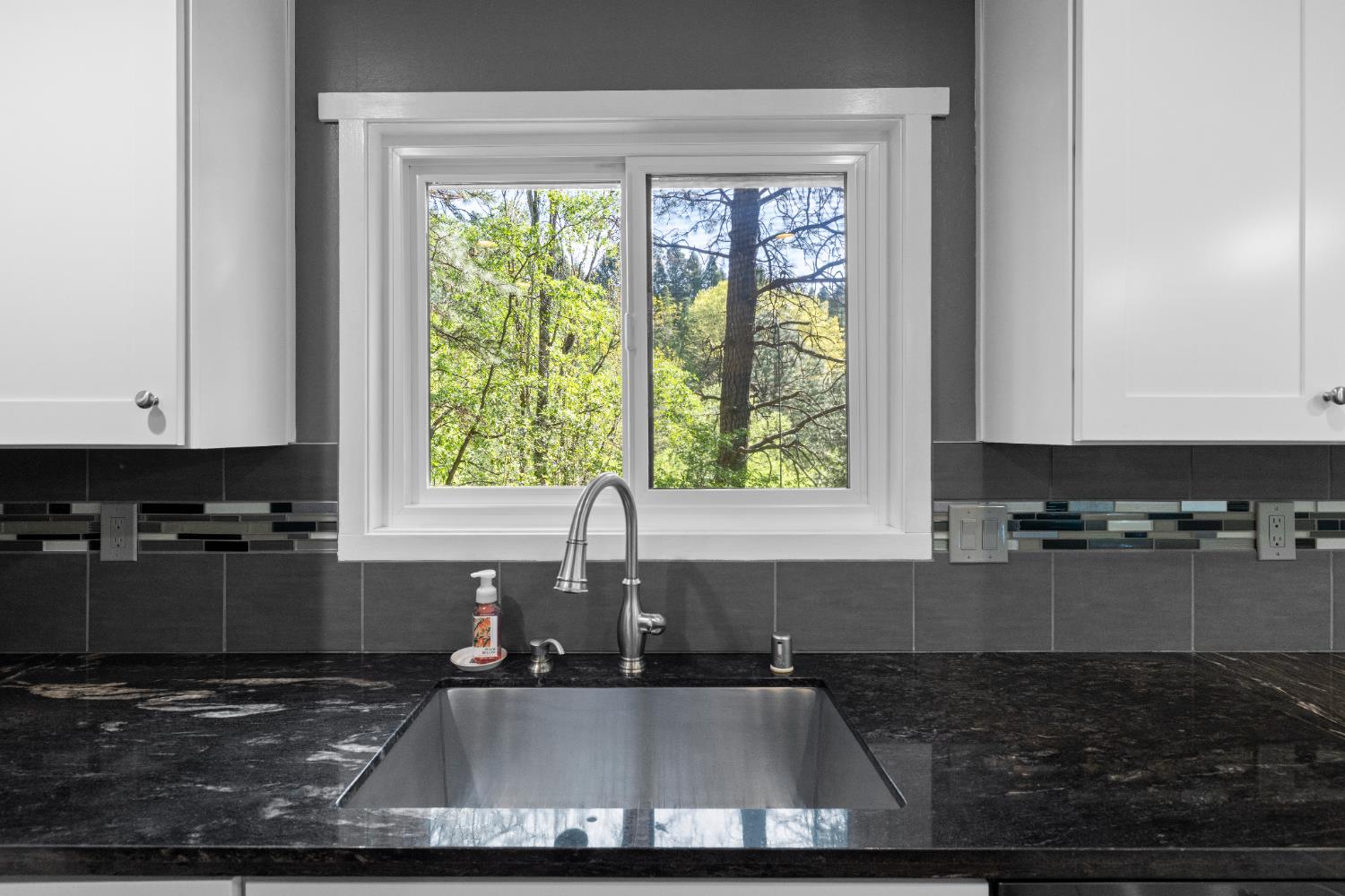 16173 Norlene Way Grass Valley, CA 95949 - Photo 19 of 25 a kitchen with a large window cabinets and appliances