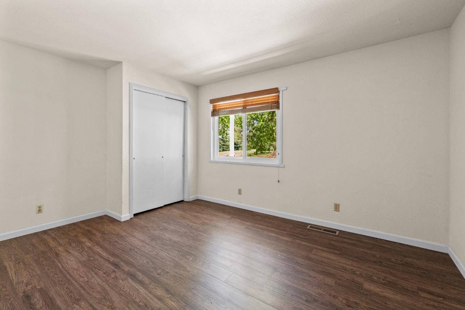 16173 Norlene Way Grass Valley, CA 95949 - Photo 21 of 25 an empty room with wooden floor and windows