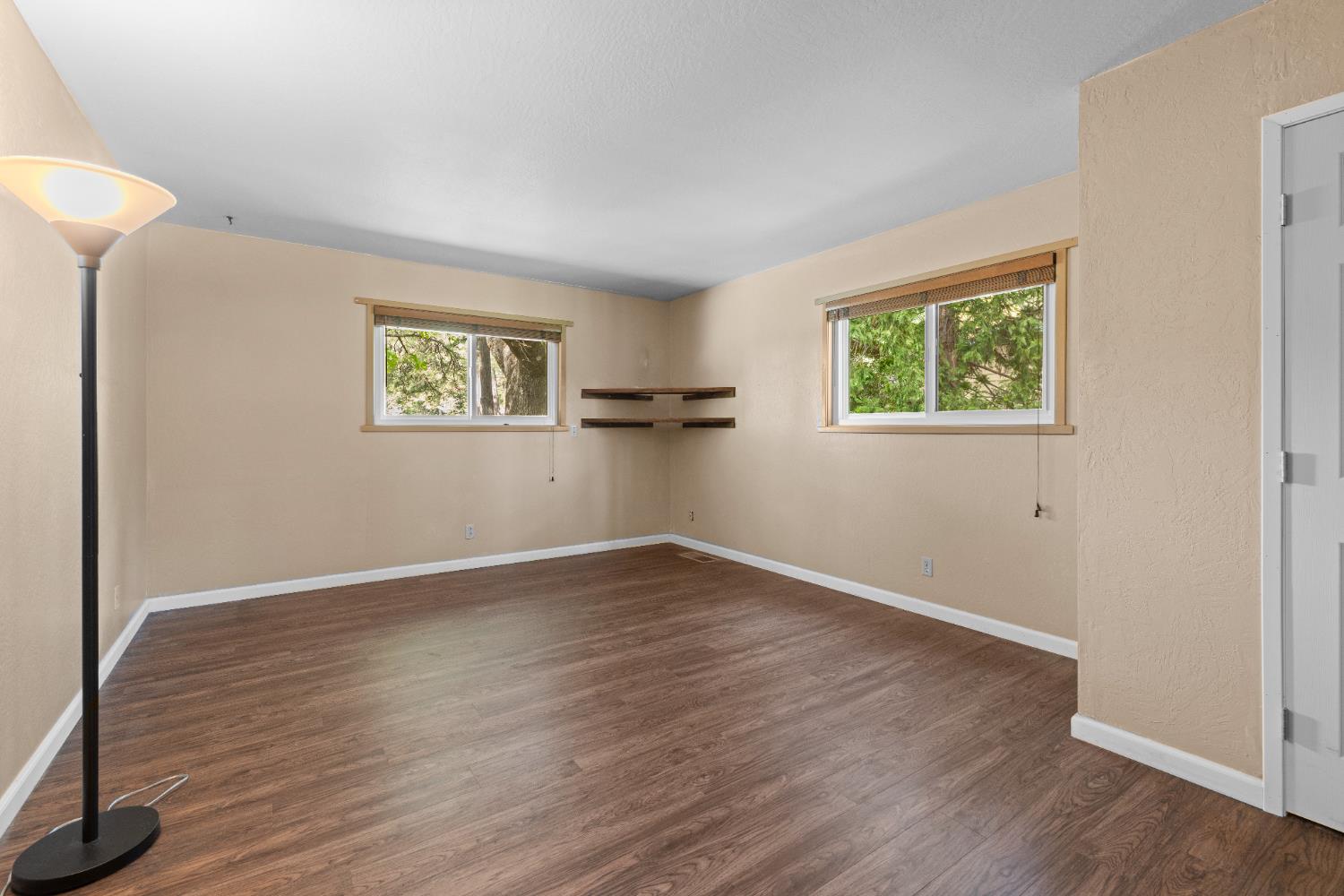 16173 Norlene Way Grass Valley, CA 95949 - Photo 22 of 25 an empty room with wooden floor and windows