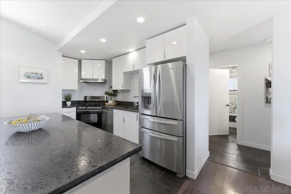 a kitchen with a refrigerator a sink and cabinets