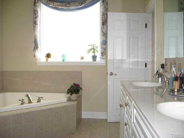 1300 Red Brick Road Garner, NC 27529 - Photo 6 of 12 a bath room with a sink and a mirror