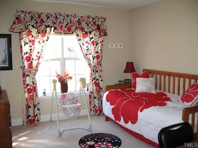1300 Red Brick Road Garner, NC 27529 - Photo 8 of 12 a bedroom with bed and a window
