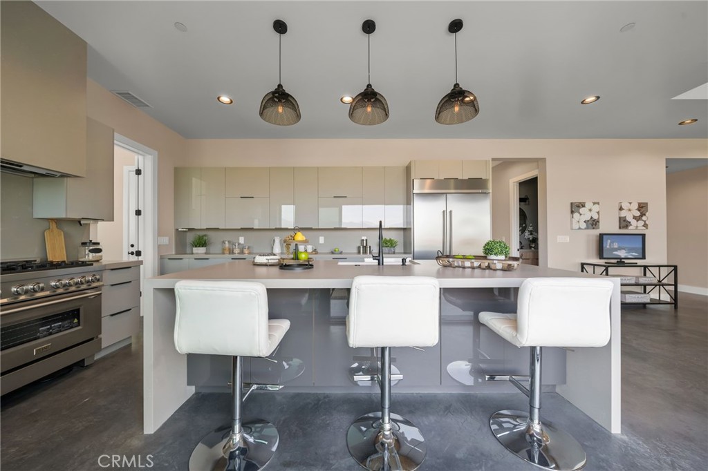 2380 Scenic Ridge Drive Chino Hills, CA 91709 - Photo 24 of 67 a kitchen with stainless steel appliances granite countertop a stove a sink a dining table and chairs with wooden floor