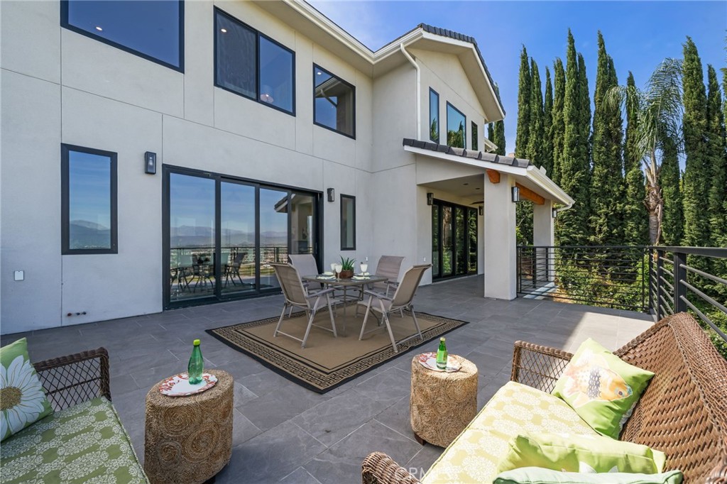 2380 Scenic Ridge Drive Chino Hills, CA 91709 - Photo 30 of 67 a view of a patio with couches table and chairs and potted plants