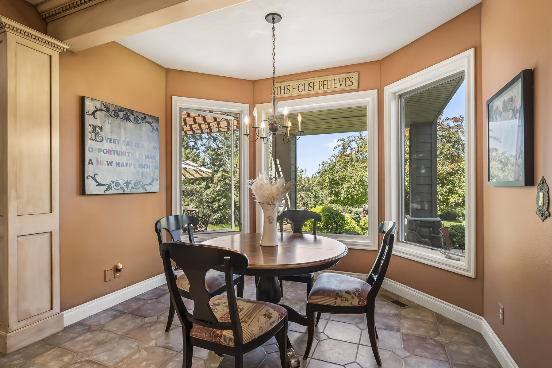 61445 Gosney Road Bend, OR 97702 - Photo 43 of 83 a dining room with furniture a chandelier and wooden floor
