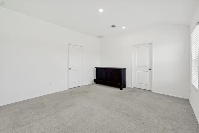 an empty room with white wall and window