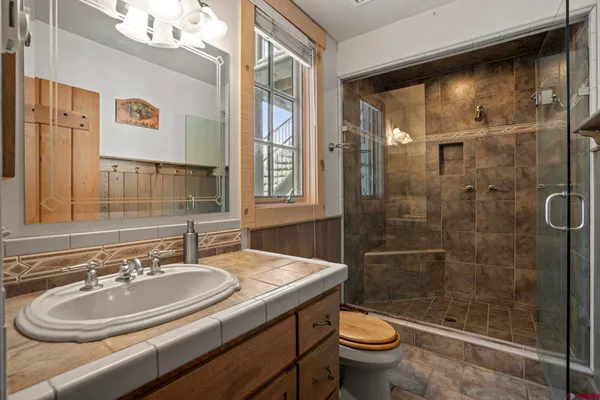 a bathroom with a sink toilet and shower