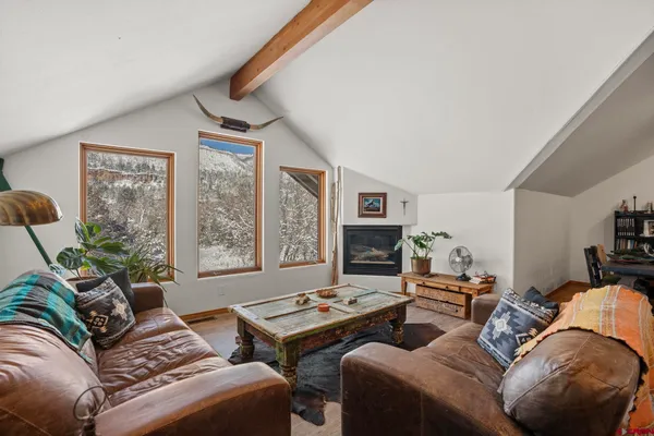 a living room with furniture and a floor to ceiling window