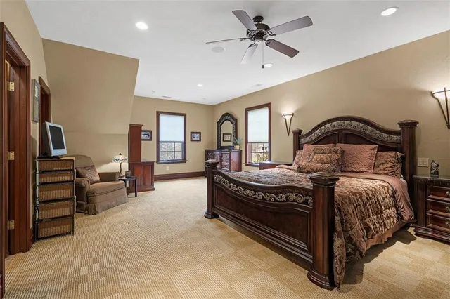 a bedroom with a bed and a chandelier
