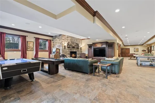 a living room with furniture a flat screen tv and a large window