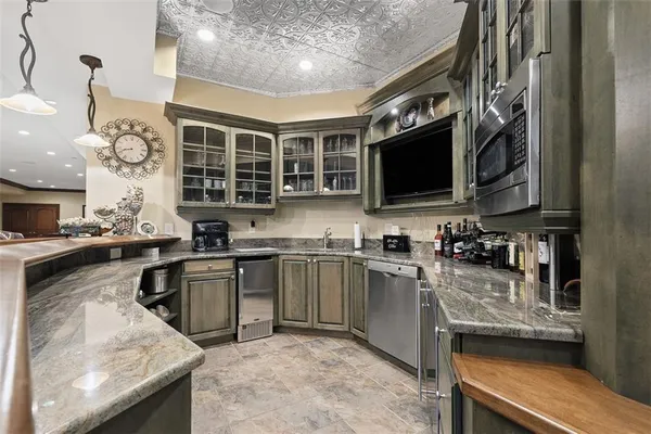 a kitchen with stainless steel appliances granite countertop a sink stove microwave and cabinets