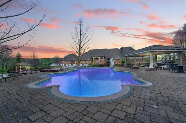 a view of a swimming pool with a yard