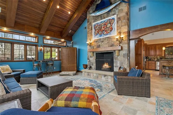 a living room with patio furniture and a fireplace