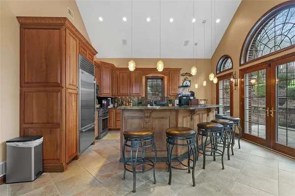 a dining area with furniture and a large window