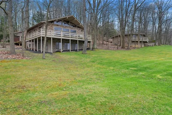 a view of a house with a backyard