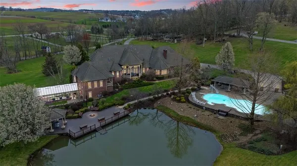 an aerial view of a house with a lake view