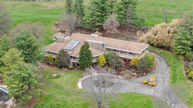 an aerial view of a house with yard swimming pool and outdoor seating