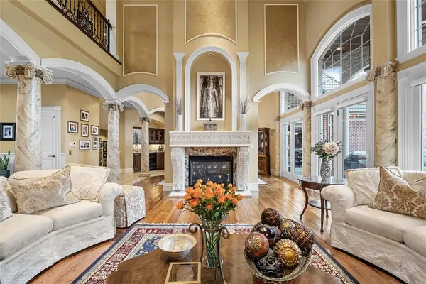 a living room with furniture fireplace and a large window