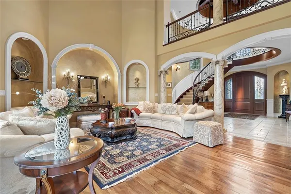 a living room with couches chairs and a chandelier