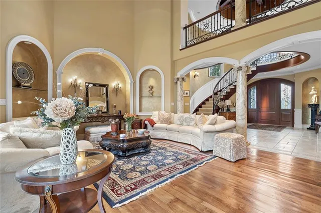 a living room with couches chairs and a chandelier