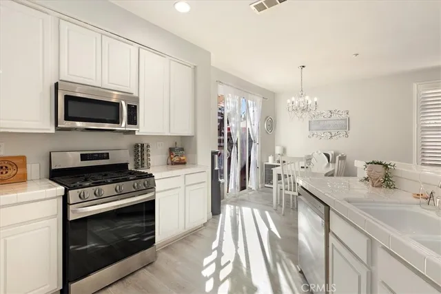 a kitchen with a sink stove and microwave