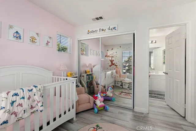 a bedroom with baby crib and furniture