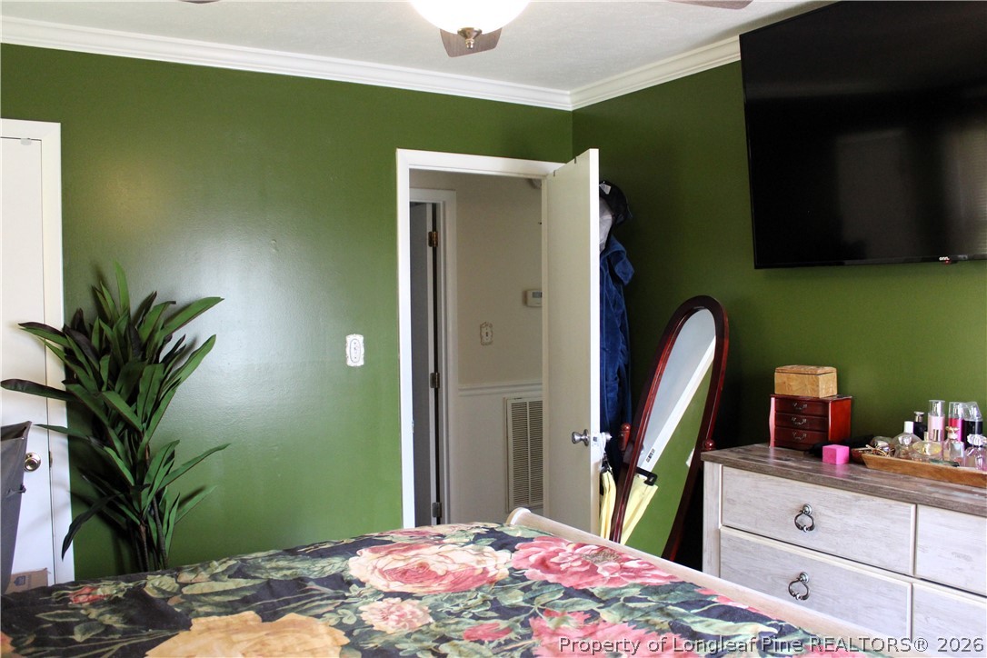 2038 Dunn Road Eastover, NC 28312 - Photo 15 of 29 a bedroom with a bed and a potted plant