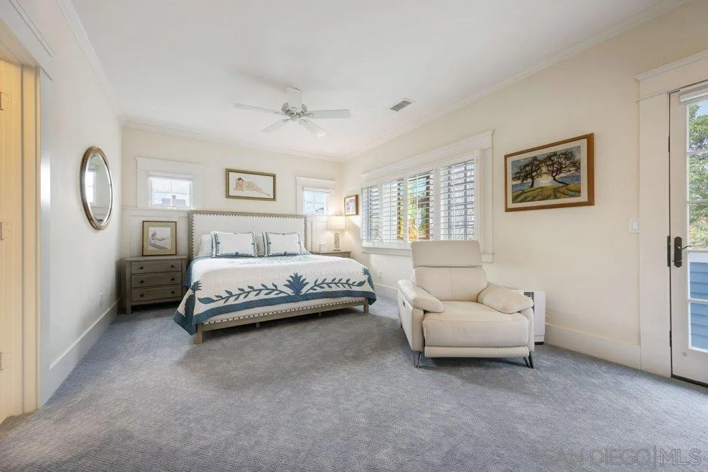 603 J Avenue Coronado, CA 92118 - Photo 12 of 22 a bedroom with a bed and a chandelier
