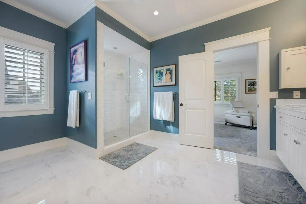 603 J Avenue Coronado, CA 92118 - Photo 14 of 22 a bedroom with a bed and a large mirror