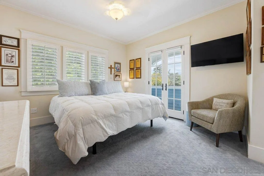 603 J Avenue Coronado, CA 92118 - Photo 15 of 22 a bedroom with a bed a couch and a flat screen television