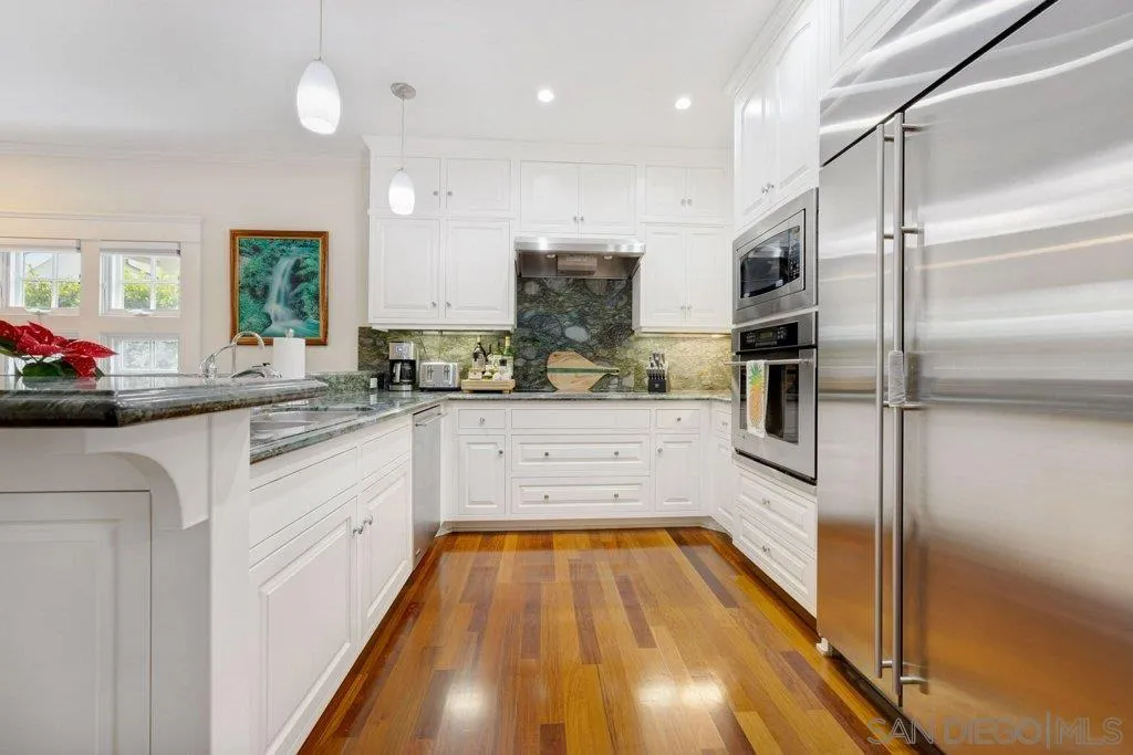 603 J Avenue Coronado, CA 92118 - Photo 5 of 22 a kitchen with stainless steel appliances a refrigerator sink and cabinets