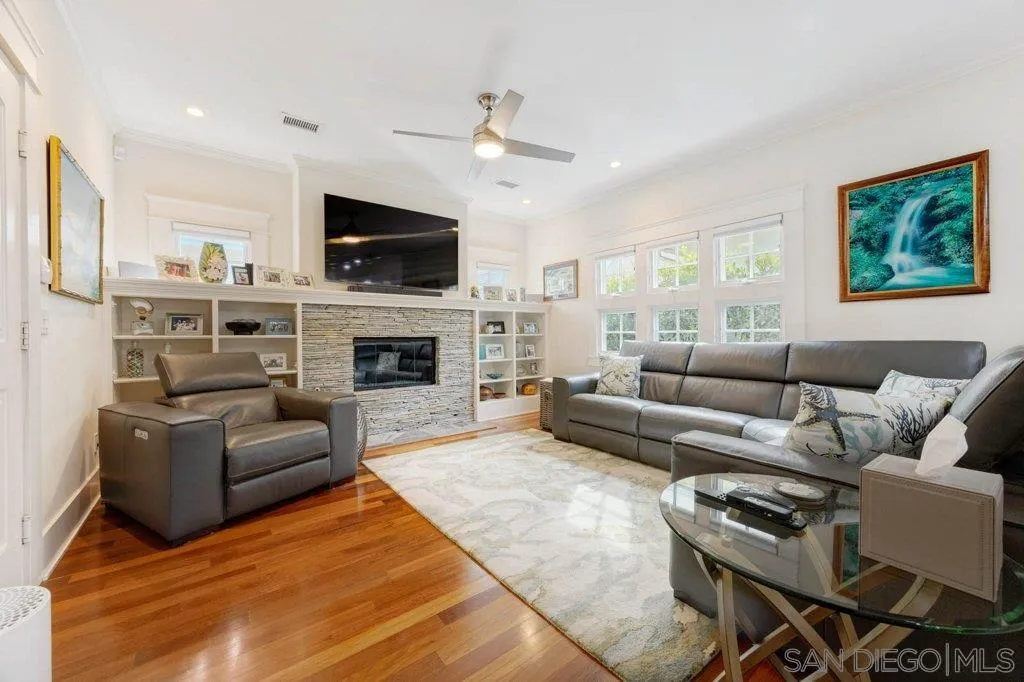 603 J Avenue Coronado, CA 92118 - Photo 6 of 22 a living room with furniture a flat screen tv and a fireplace