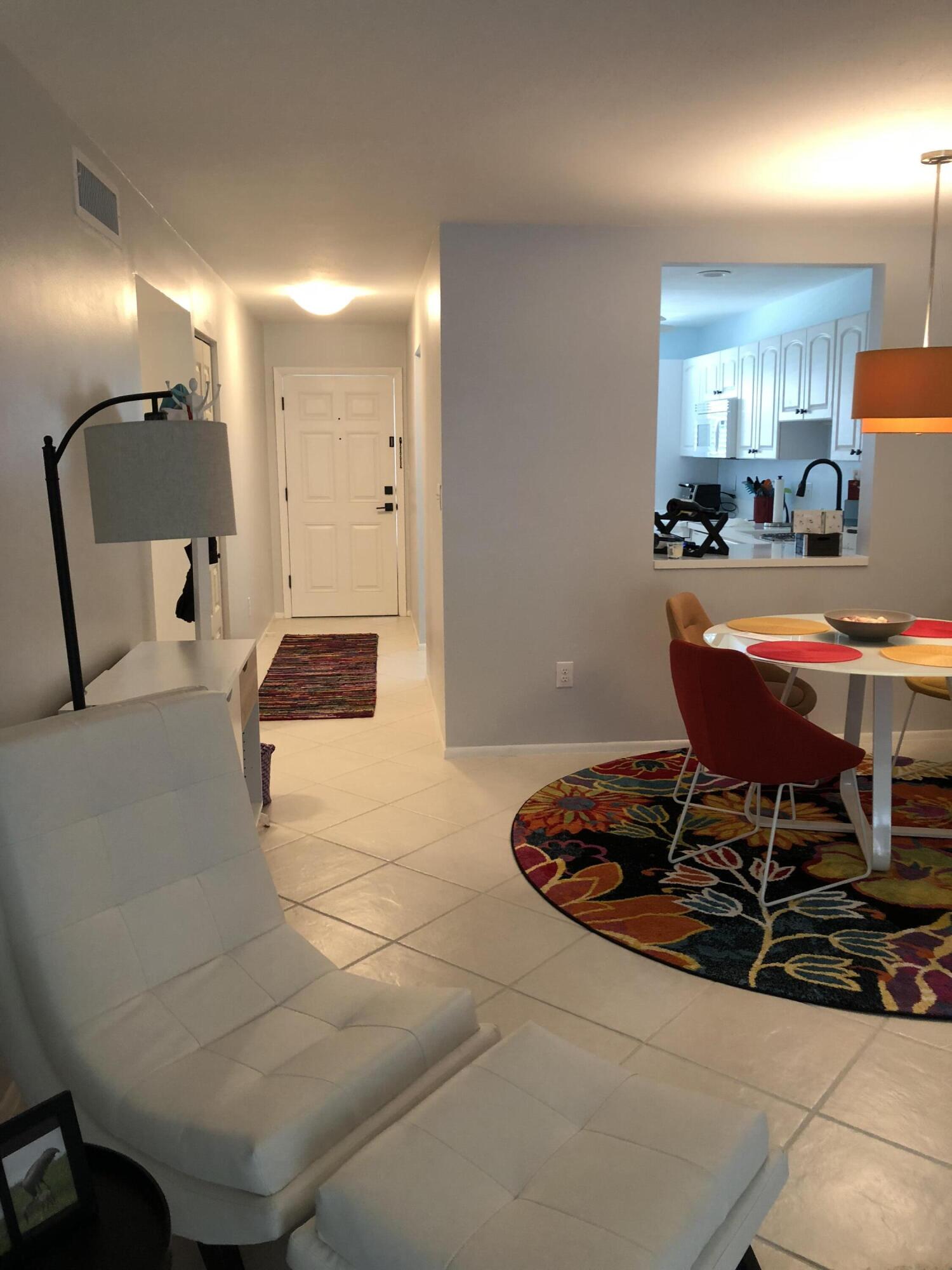 1225 Carlton Court, Unit 202 Fort Pierce, FL 34949 - Photo 13 of 15 a living room with furniture and a table