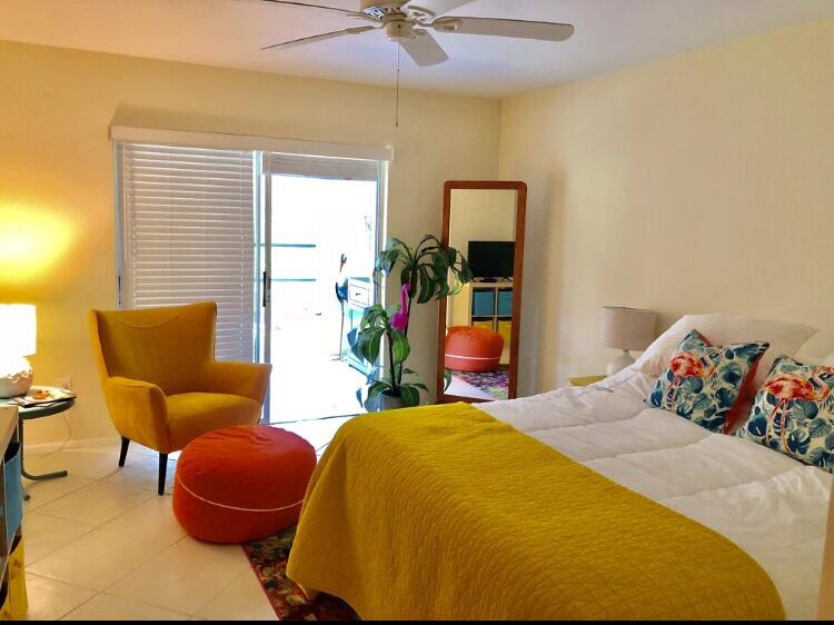 1225 Carlton Court, Unit 202 Fort Pierce, FL 34949 - Photo 3 of 15 a bed room with a bed and a chair