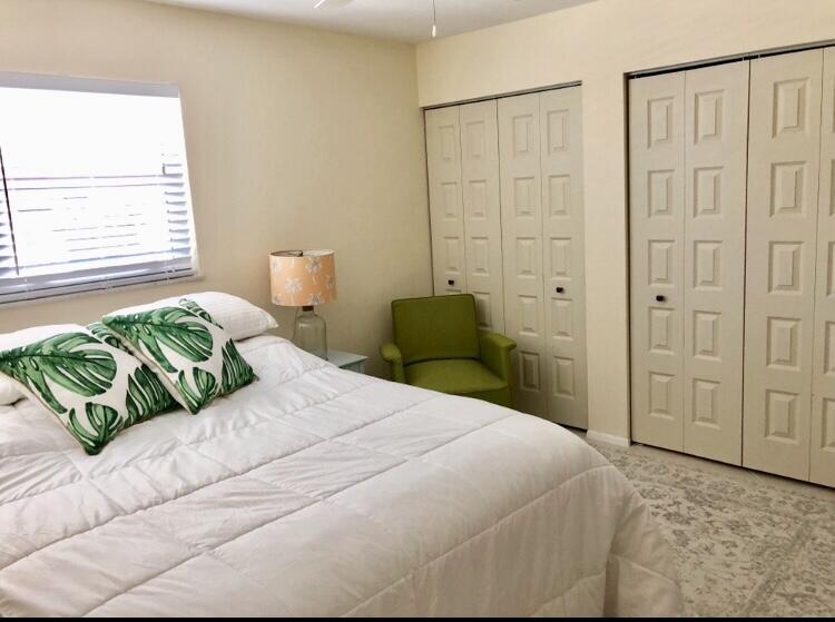 1225 Carlton Court, Unit 202 Fort Pierce, FL 34949 - Photo 5 of 15 a bedroom with a bed mirror and window