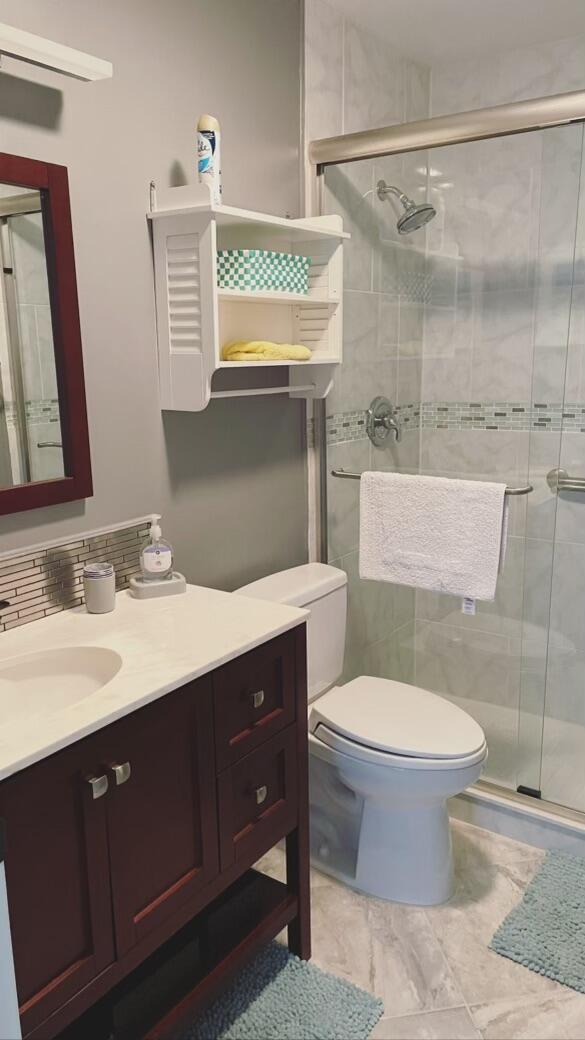 1225 Carlton Court, Unit 202 Fort Pierce, FL 34949 - Photo 6 of 15 a bathroom with a sink toilet and shower