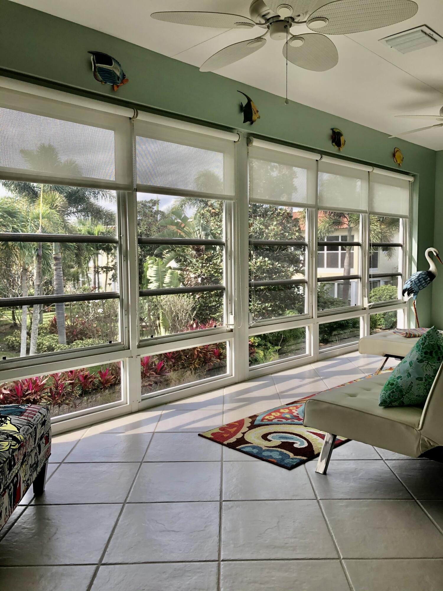 1225 Carlton Court, Unit 202 Fort Pierce, FL 34949 - Photo 8 of 15 a living room with furniture a floor to ceiling window and pool table