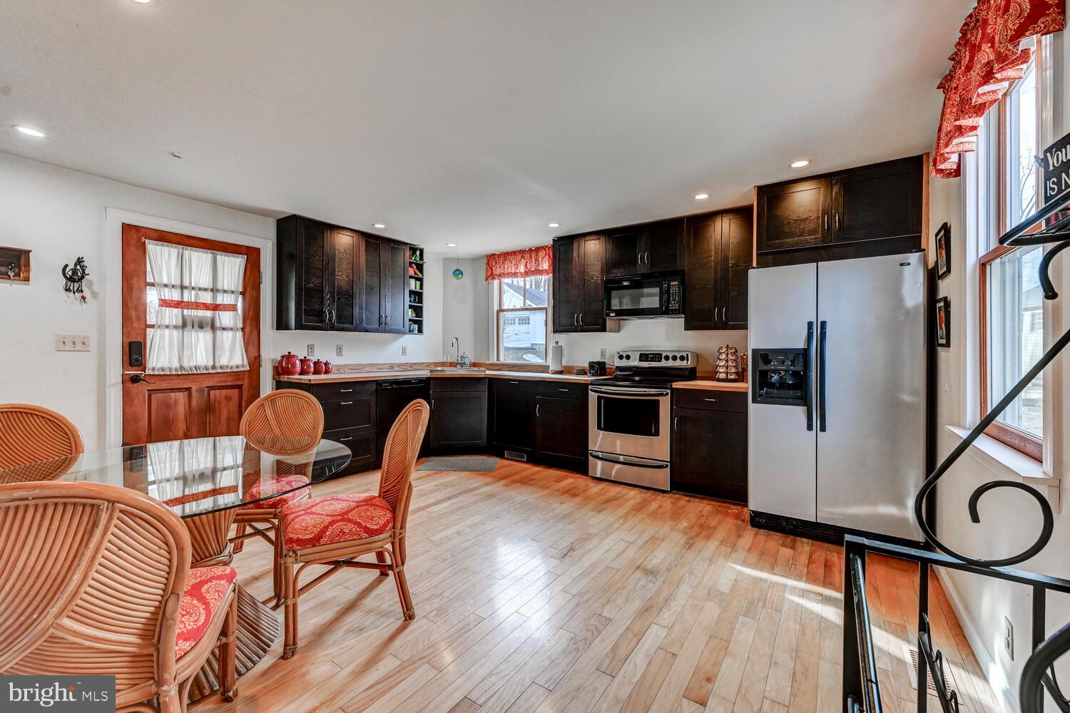 1911 Monkton Road Monkton, MD 21111 - Photo 13 of 35 a kitchen with stainless steel appliances a microwave a stove a sink dishwasher a dining table and chairs with wooden floor