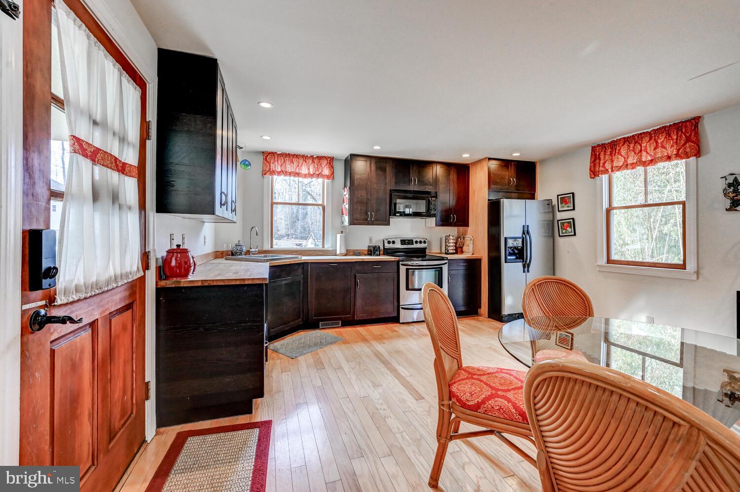 1911 Monkton Road Monkton, MD 21111 - Photo 17 of 35 a kitchen with stainless steel appliances kitchen island granite countertop a stove top oven a sink and a refrigerator