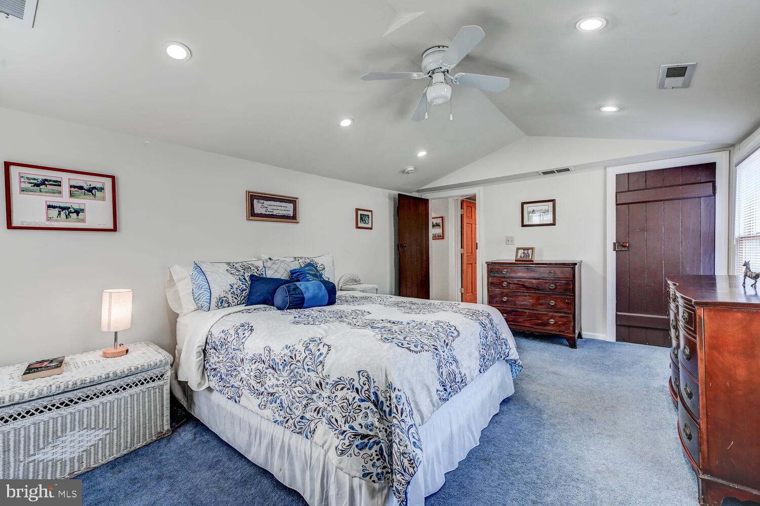 1911 Monkton Road Monkton, MD 21111 - Photo 22 of 35 a spacious bedroom with a bed and a chandelier