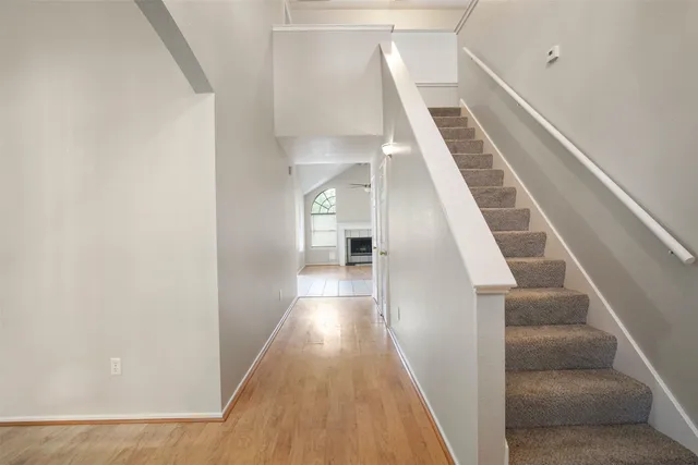 a view of entryway and hall with wooden floor