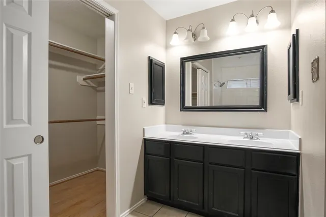 a bathroom with a double vanity sink mirror and
