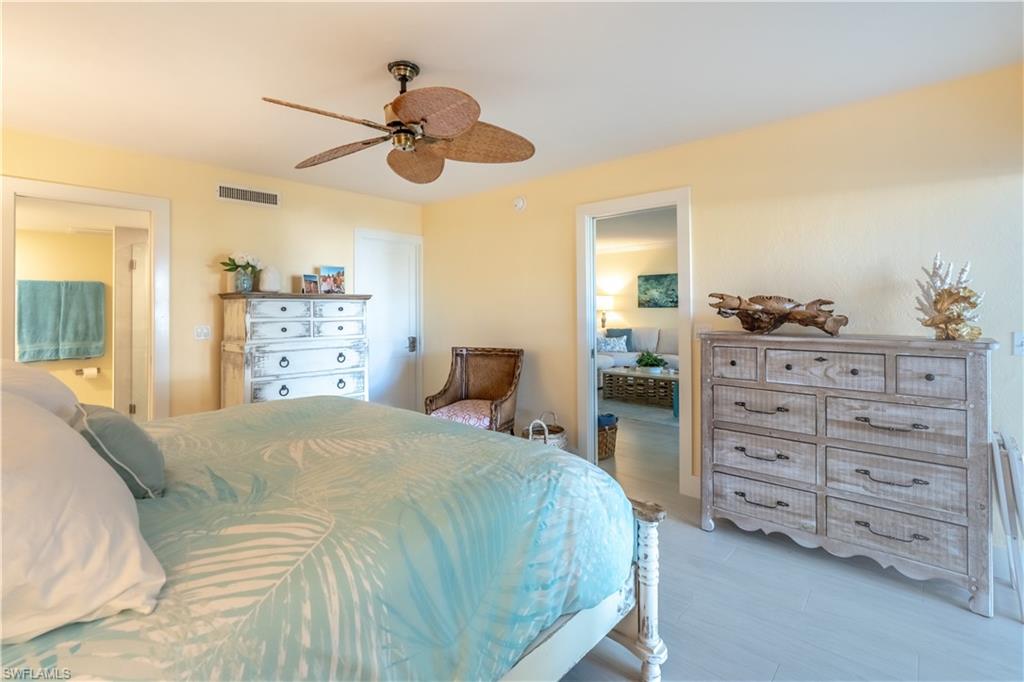 1071 8th Street South, Unit 103 Naples, FL 34102 - Photo 15 of 31 a bedroom with a bed and a dresser
