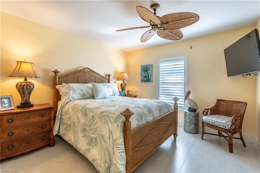 1071 8th Street South, Unit 103 Naples, FL 34102 - Photo 18 of 31 a bedroom with a bed and a television