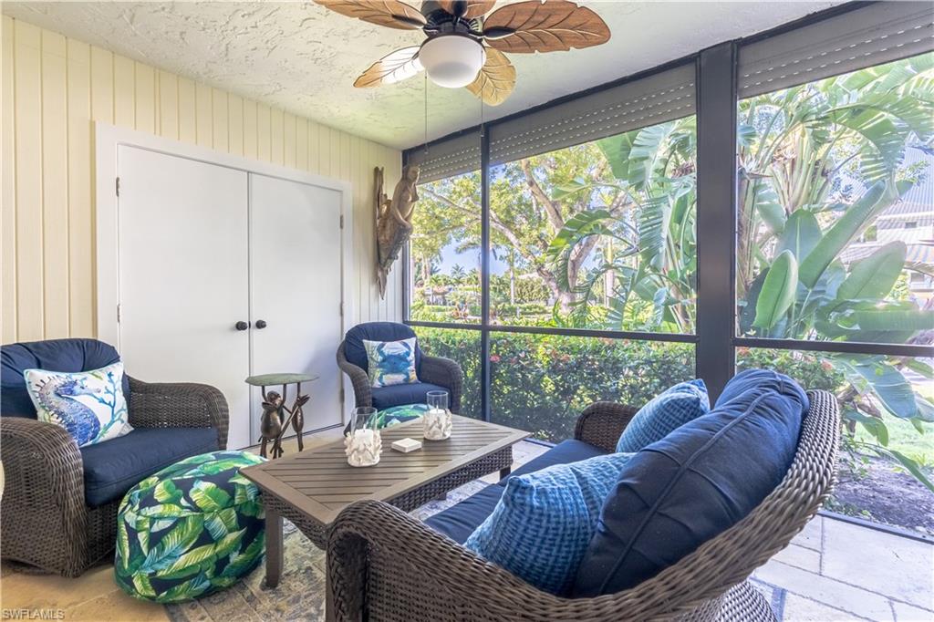 1071 8th Street South, Unit 103 Naples, FL 34102 - Photo 23 of 31 a living room with furniture and a large window
