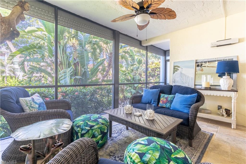 1071 8th Street South, Unit 103 Naples, FL 34102 - Photo 24 of 31 a living room with furniture and a large window