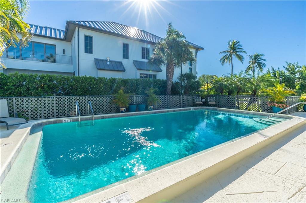 1071 8th Street South, Unit 103 Naples, FL 34102 - Photo 27 of 31 a view of a swimming pool with a garden