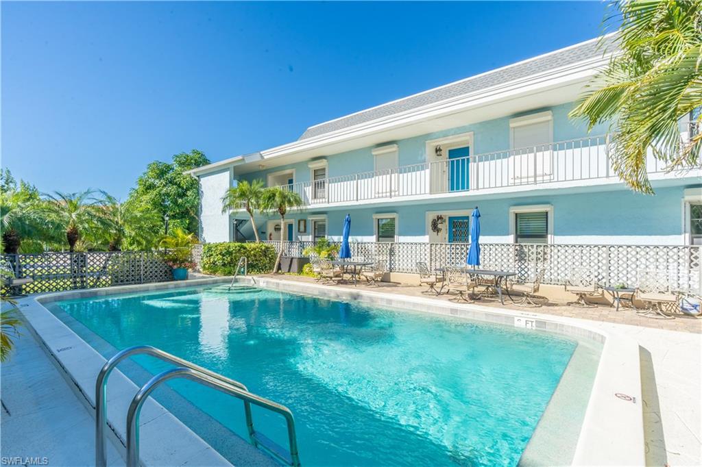 1071 8th Street South, Unit 103 Naples, FL 34102 - Photo 28 of 31 a view of pool with outdoor seating