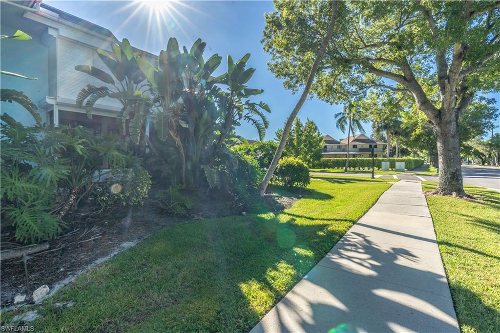 1071 8th Street South, Unit 103 Naples, FL 34102 - Photo 30 of 31 a view of a backyard with swimming pool