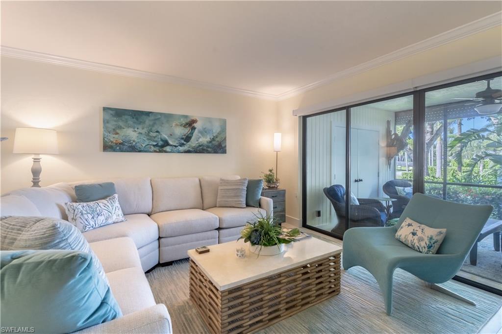 1071 8th Street South, Unit 103 Naples, FL 34102 - Photo 3 of 31 a living room with furniture and a large window